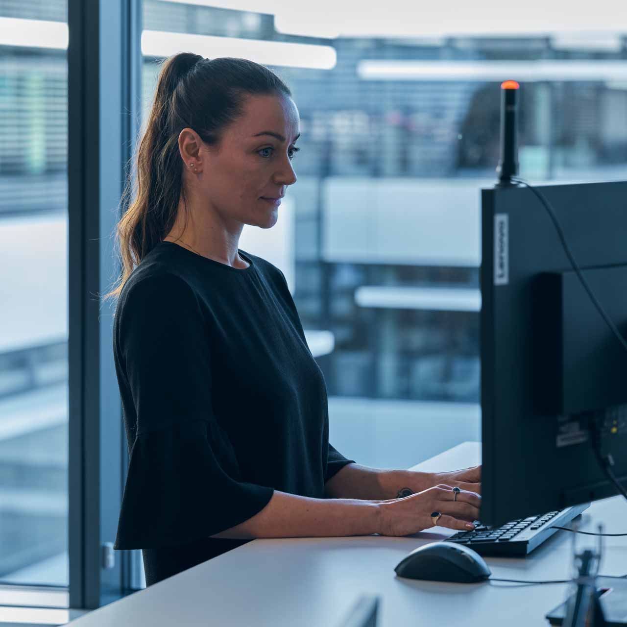 A professional woman working at her desk in an office environment